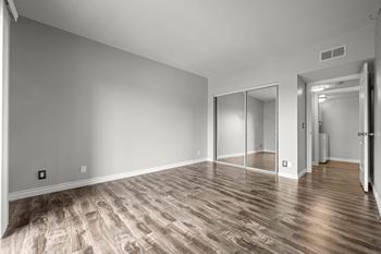 A room with wooden flooring and a sliding door at Lafayette Apartments, Los Angeles, CA